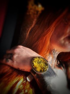 a woman with red hair wearing a watch