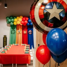 the table is set up for a party with captain america balloons