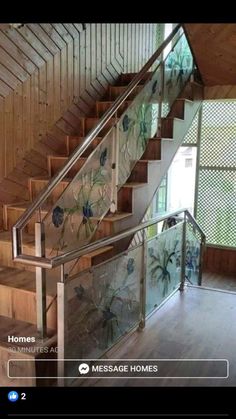 a stair case with glass flowers on the bottom and handrails, in front of a window