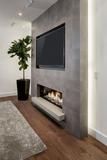 a living room with a tv mounted on the wall and a fire place in front of it