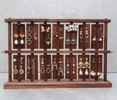 a wooden display with earrings on it