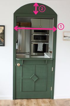 a green door with pink arrows pointing to the left and an arrow pointing towards the right