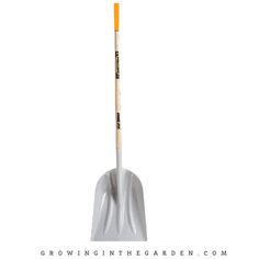 a white shovel with yellow handle and wooden handles on the tip is standing upright in front of a white background