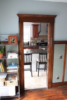 an open door leading to a kitchen and dining room