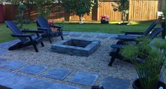 an outdoor fire pit surrounded by lawn chairs