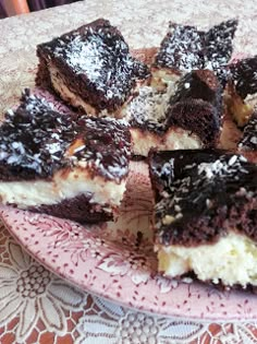 a plate that has some desserts on it and is sitting on a doily