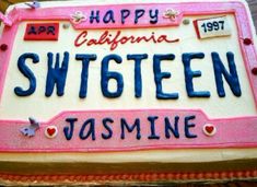 a cake decorated with the name of a woman's state is shown in pink and white