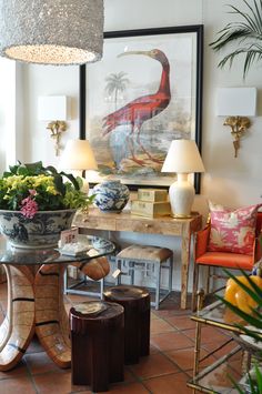 a living room filled with lots of furniture and flowers on top of a glass table