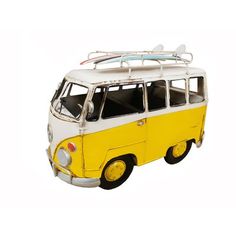 a yellow and white vw bus with surfboards on top is shown against a white background