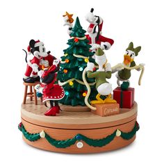 the mickey mouse figurines are all dressed up and ready to be put into the christmas tree