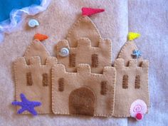 a sand castle made out of felt and buttons