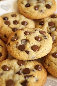 chocolate chip cookies sitting on top of a white plate