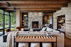 a living room filled with furniture and a fire place in the middle of it's walls