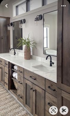 a large bathroom with double sinks and mirrors