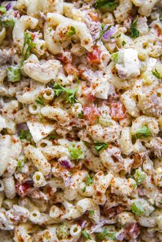 macaroni salad with cheese and vegetables in a bowl