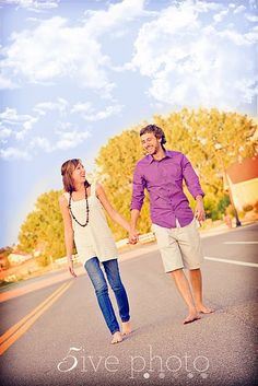 a couple holding hands while walking down the street in front of a calendar with the word weak written on it