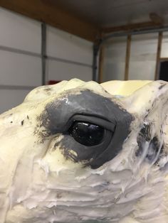 an animal made out of white and black icing in a room with a garage door