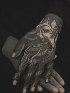 a person with tattoos on their hands and hand