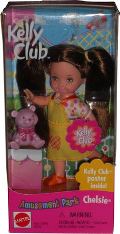 the doll is wearing a yellow dress and has a pink bear on her chest,