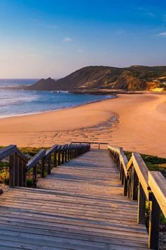 a wooden staircase leading down to the beach