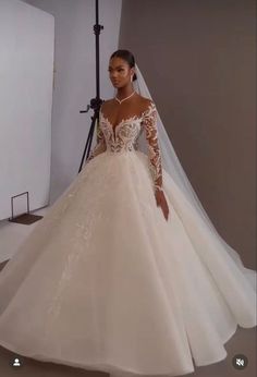 a woman in a wedding dress posing for the camera