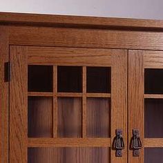 a large wooden cabinet with glass doors