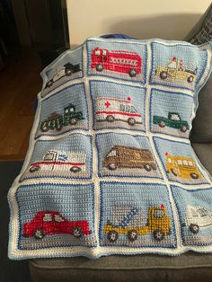 a crocheted blanket with cars and trucks on it is sitting on a couch