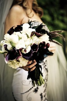 a bride holding a bouquet of flowers in her hand