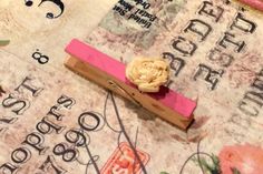 a piece of pink paper with a flower on it sitting on top of a table