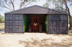 the tractor is parked in the storage shed