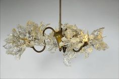 a chandelier with glass flowers hanging from it