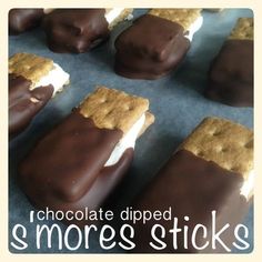 chocolate dipped s'mores sticks are arranged in rows