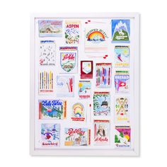 a white framed poster with various stickers on it