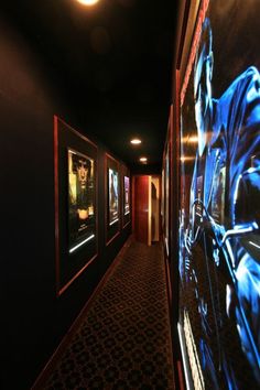 an empty hallway with posters on the wall