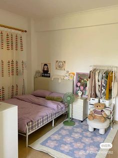 a bedroom with a bed, dresser and stuffed animal on the rug in front of it