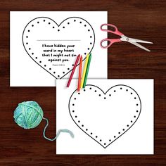 two heart shaped cards with scissors and yarn