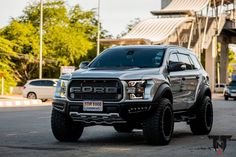 a silver truck is parked on the street