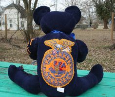 a teddy bear that is sitting on a bench