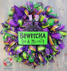 a purple and green wreath with the words bewitcha in a minute on it