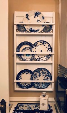 plates are stacked on the shelf above the stove