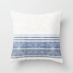 a blue and white striped pillow sitting on top of a wall