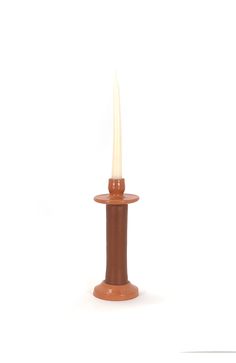 a small candle is lit on a white background