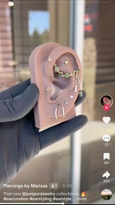 a person holding up a fake earring in their hand with the caption'piercings by maissa '