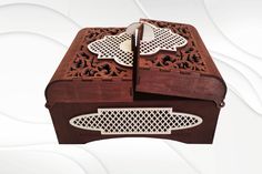 an ornately carved wooden box with two pieces cut out