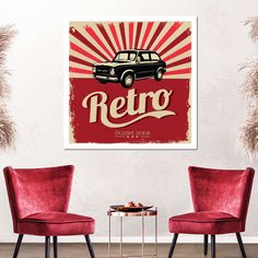 two red chairs in front of a white wall with an old - fashioned poster on it