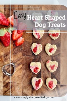 heart shaped dog treats on a cutting board with strawberries