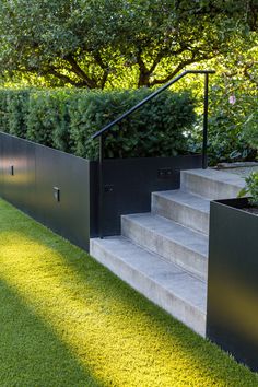 the stairs are made from concrete and have black metal railings