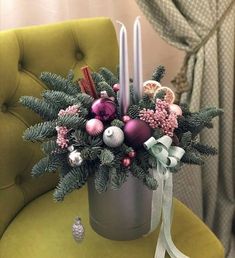 a christmas centerpiece with candles and ornaments