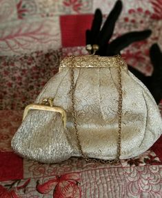 Beautiful petite gold brocade evening purse.  Ornate gold tone metal frame with a short chain.  Crystal kiss closure.   It comes with a small coin purse that nestles inside.  Creamy white inner lining with one small pocket.  Measures 6" wide x 5" tall.  Very chic look. Lenox Christmas Ornaments, Small Coin Purse, Gold Brocade, Black And White Tweed, Evening Purse, Very Merry Christmas, Vintage Victorian, Victorian Style, Creamy White