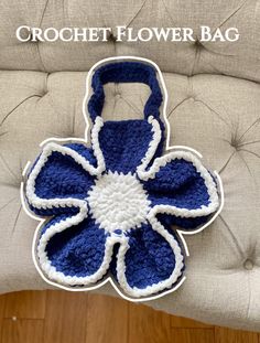 a crochet flower bag sitting on top of a chair